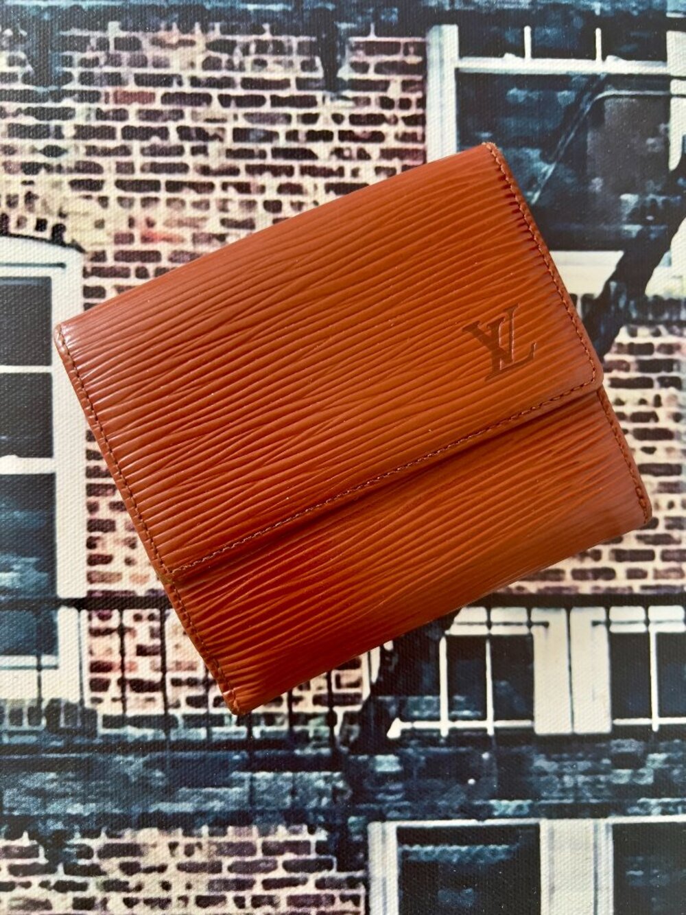 Louis Vuitton Elise trifold wallet features textured brown Epi leather